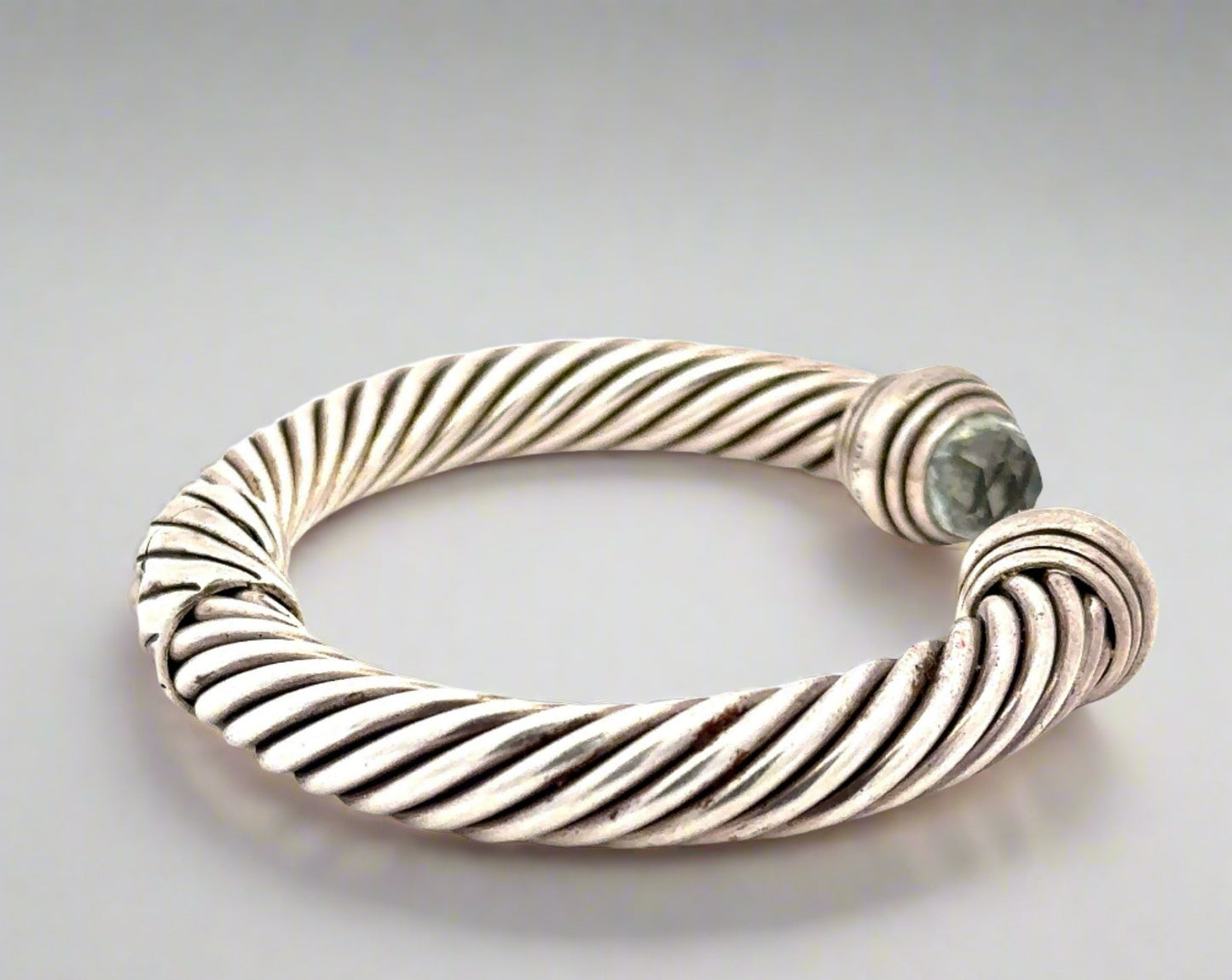 Side of silver textured bracelet with scratches on silver