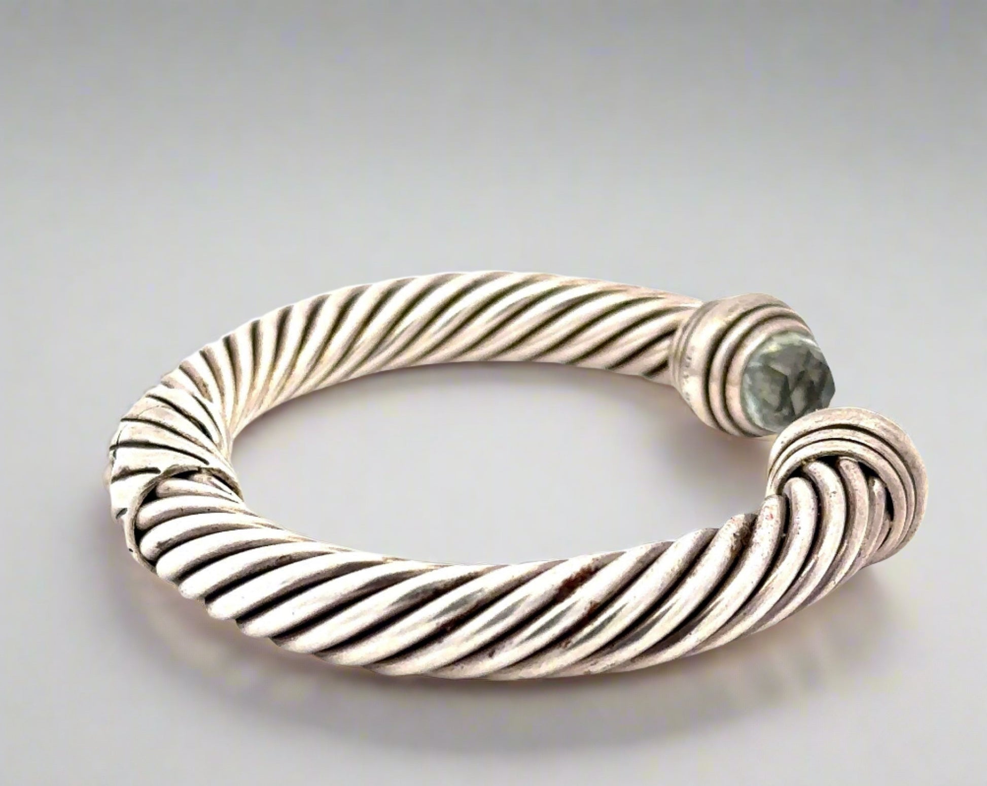 Side of silver textured bracelet with scratches on silver