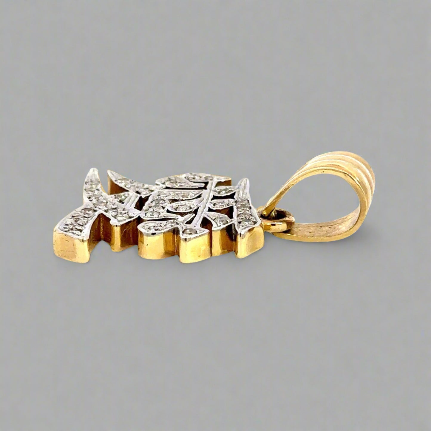 Side of pendant with round bail and marks on gold.