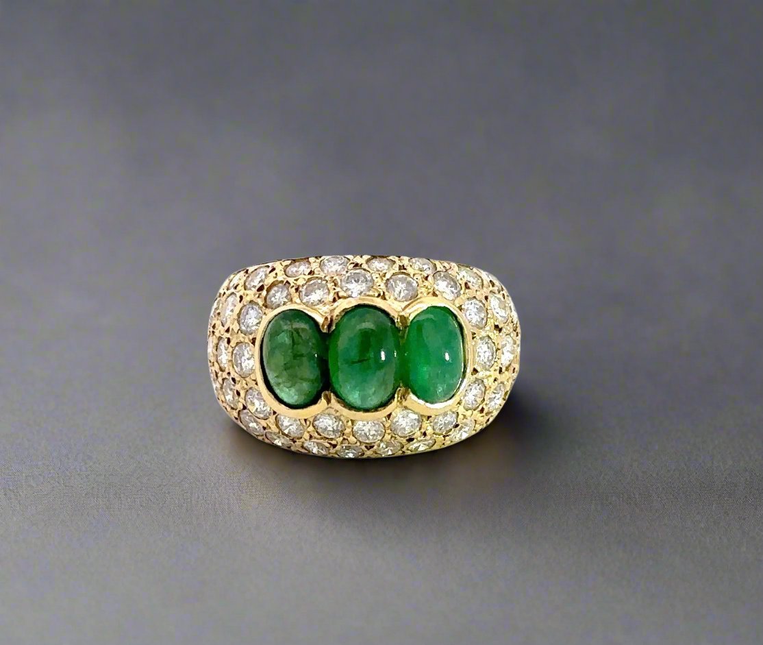 yellow gold ring with diamonds and 3 dome shaped emerald gemstones