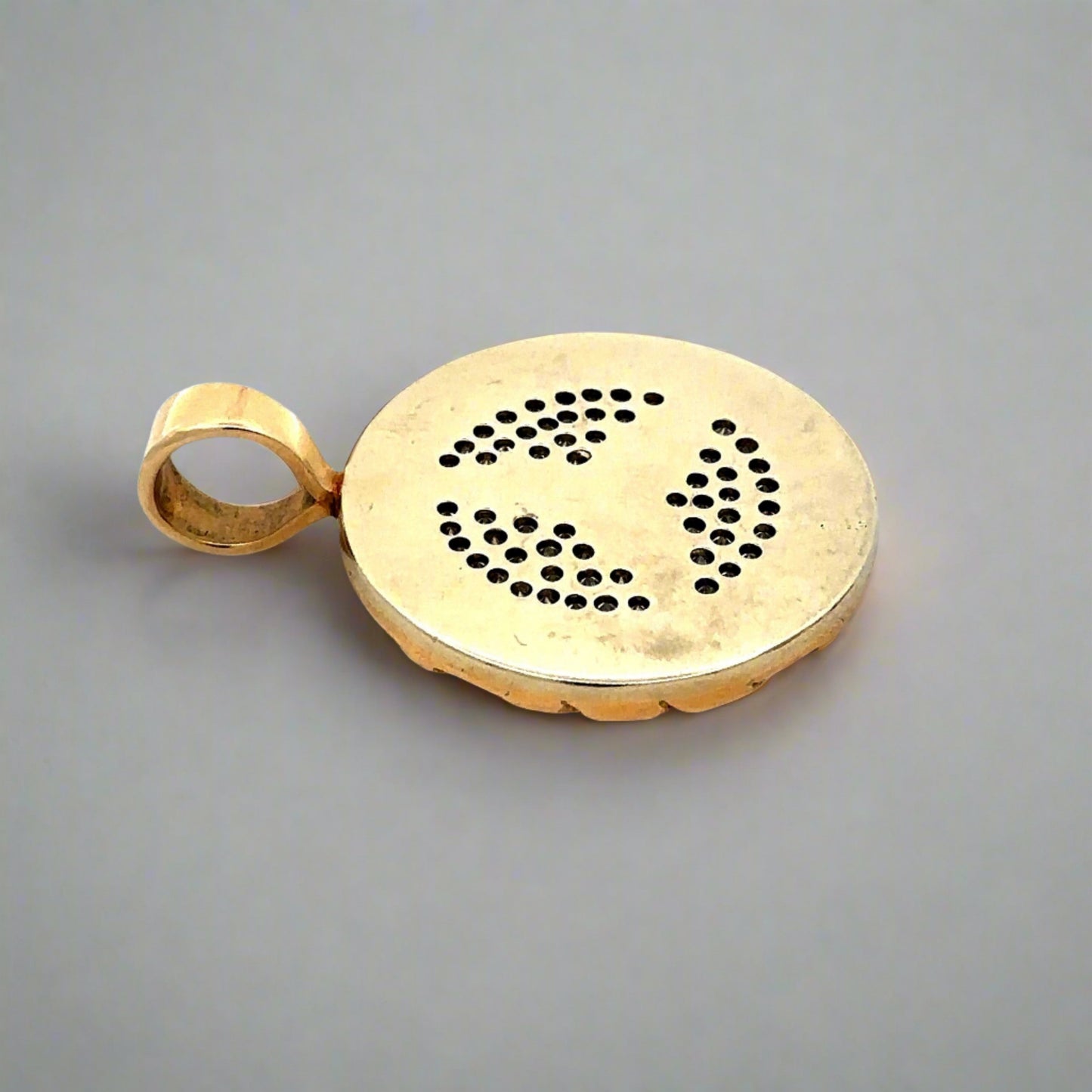 Back of pendant showing marks on gold