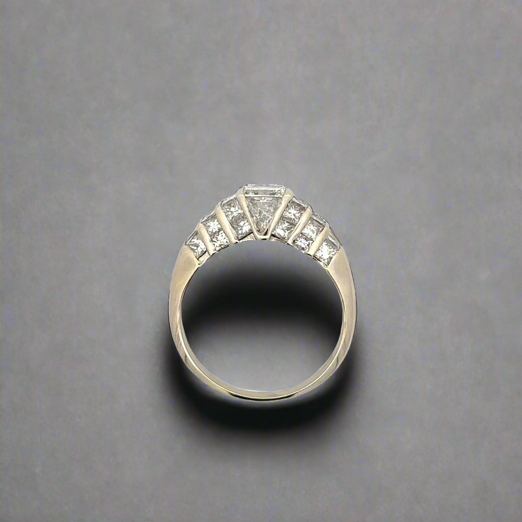 top of white gold ring with 10 small princess-cut diamonds on the side