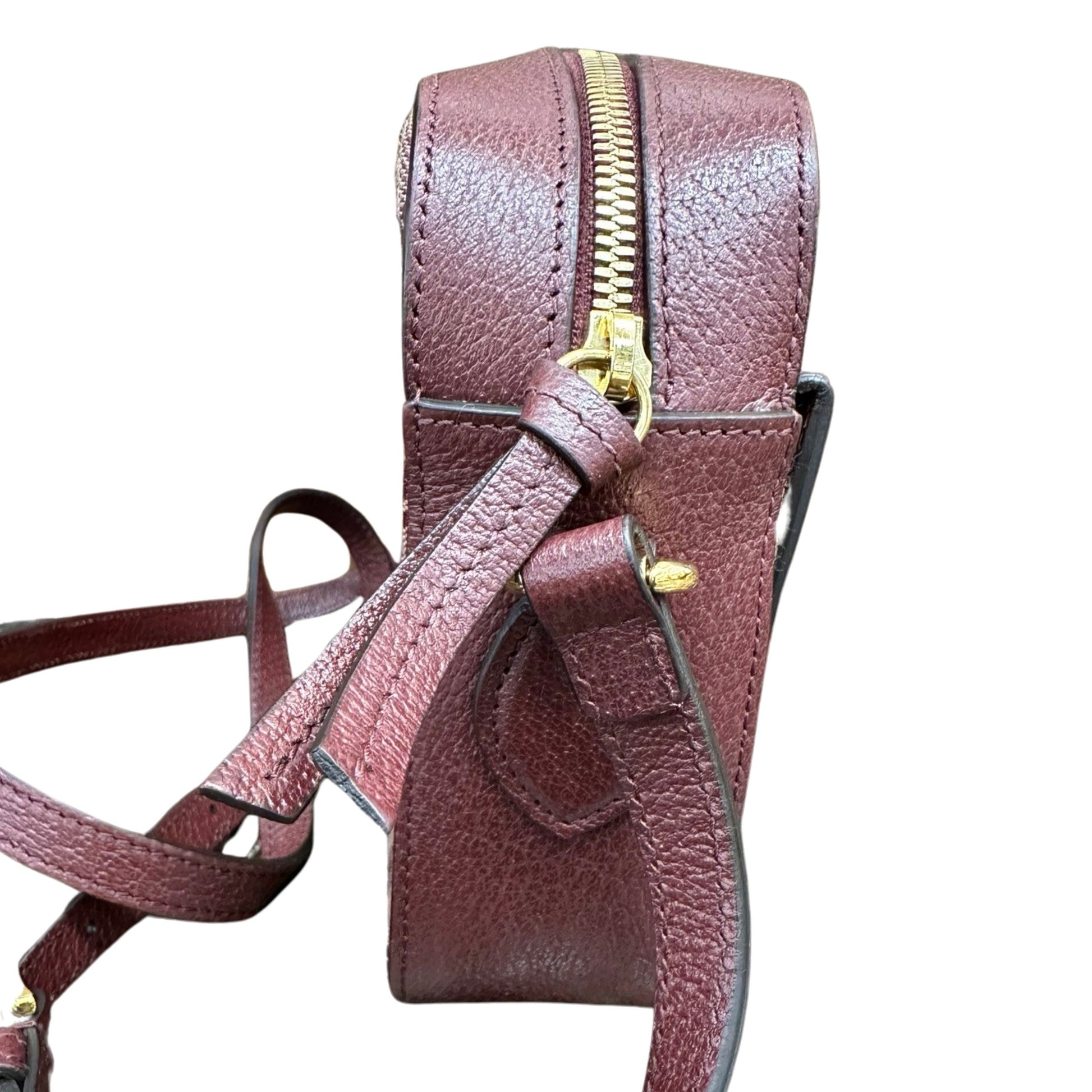 Side of bag with Burgundy leather and gold hardware