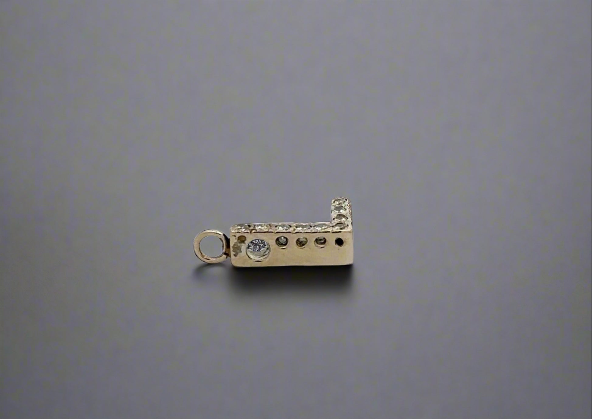 Side of L pendant with attached bail and a hole on the side