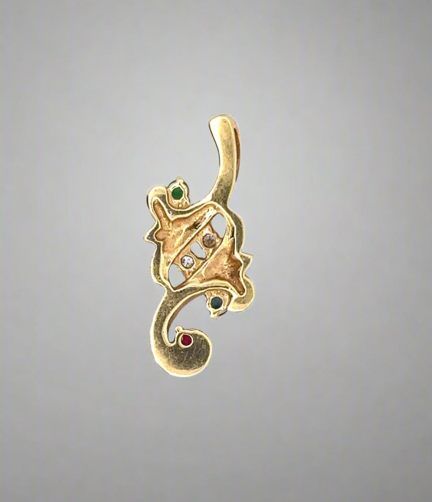 Back of yellow gold pendant with scratches