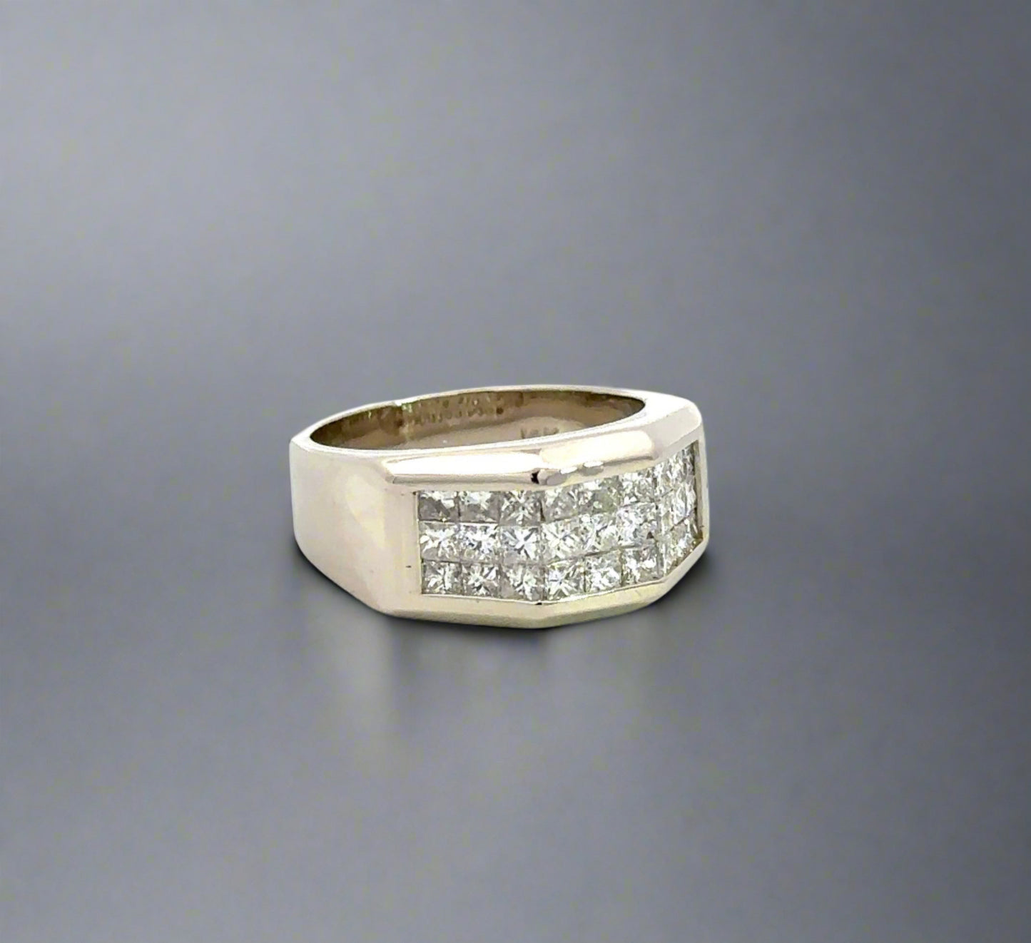Diagonal view of white gold band ring with 3 rows of princess-cut diamonds