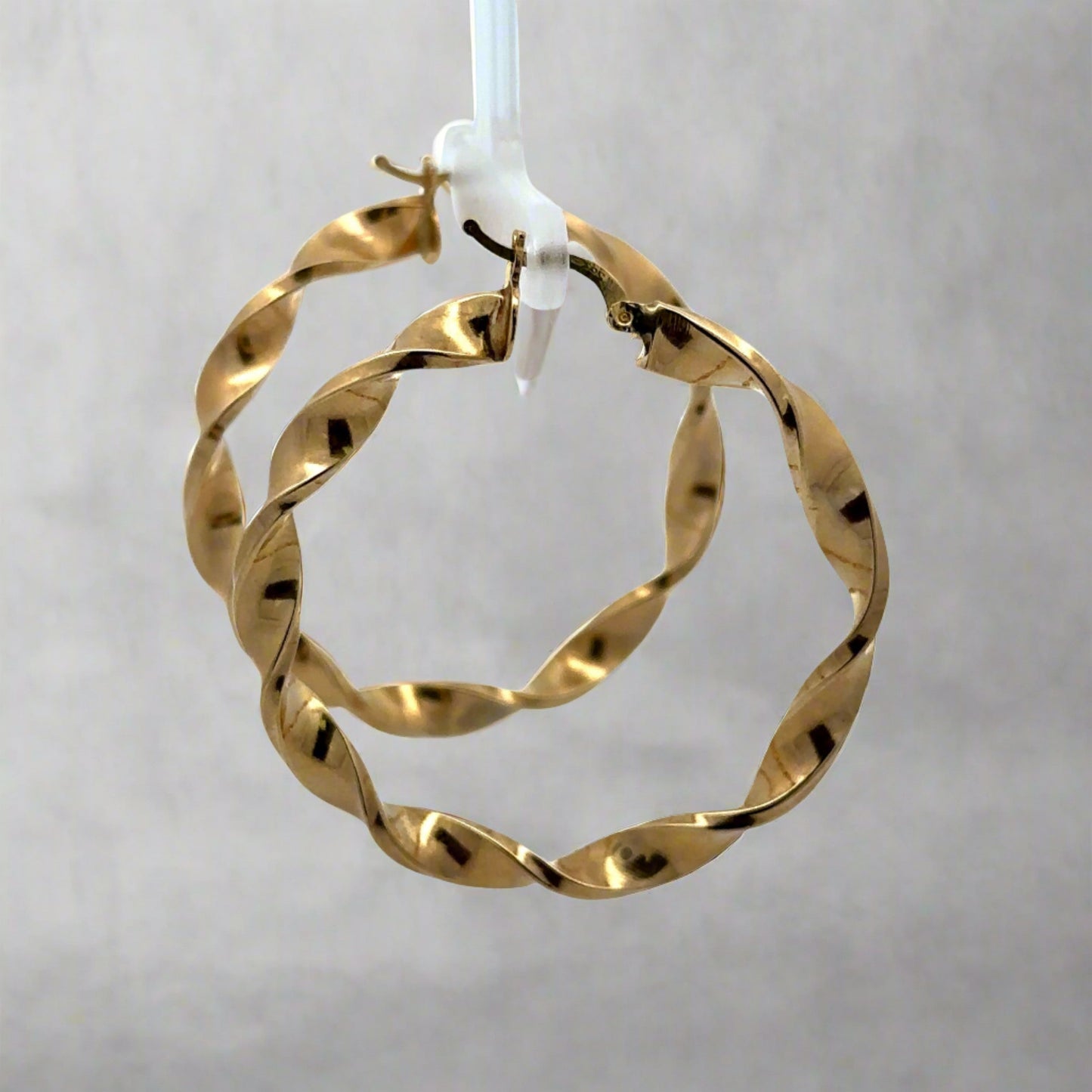 side of yellow gold twist hoops