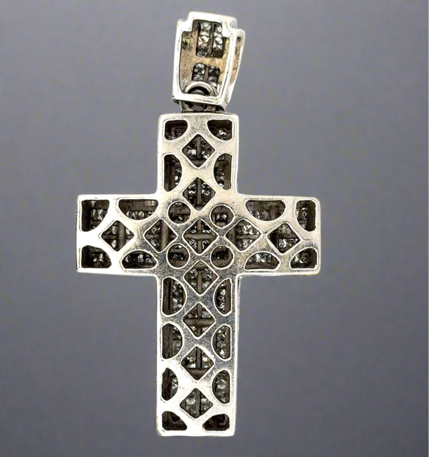 Back of white gold cross with open spaces