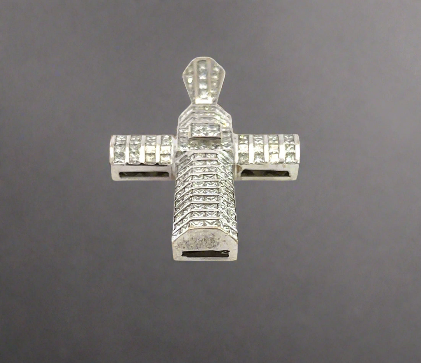 Bottom of white gold cross pendant with marks on the gold