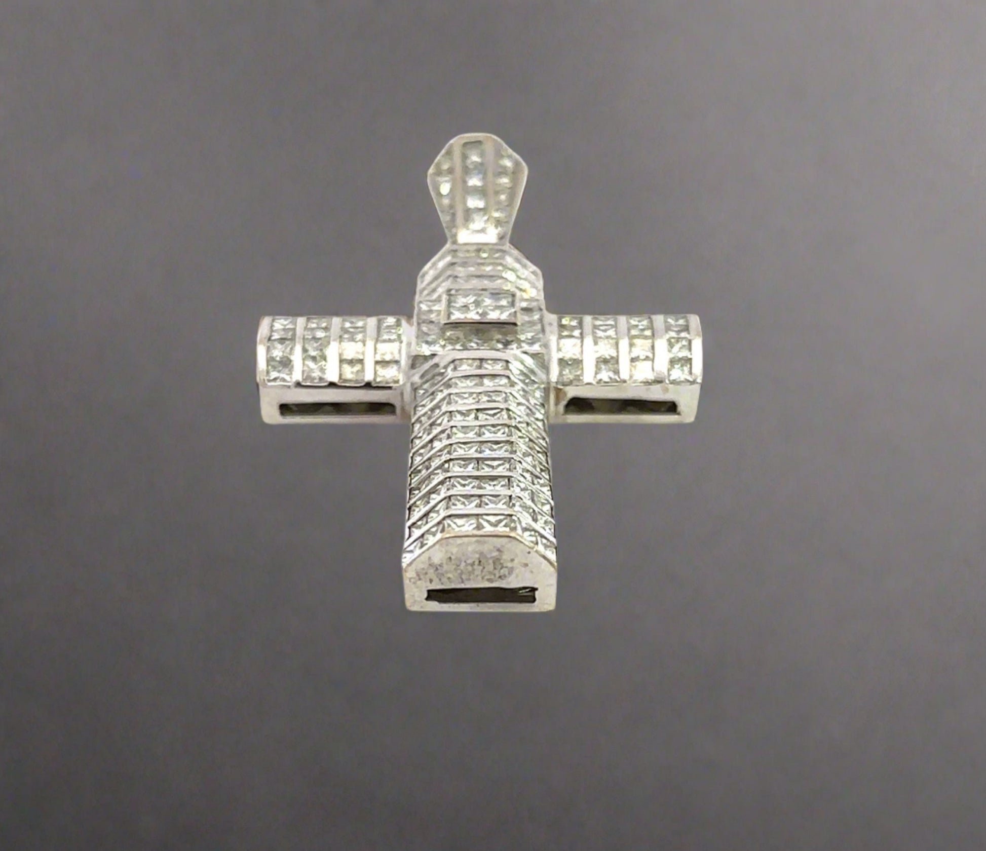 Bottom of white gold cross pendant with marks on the gold