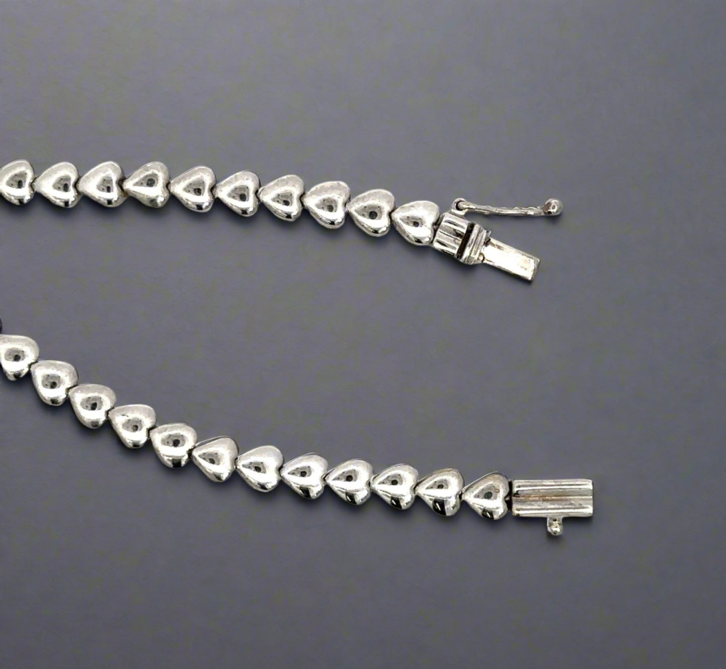 Front of clasp with white gold hearts and a safety lock