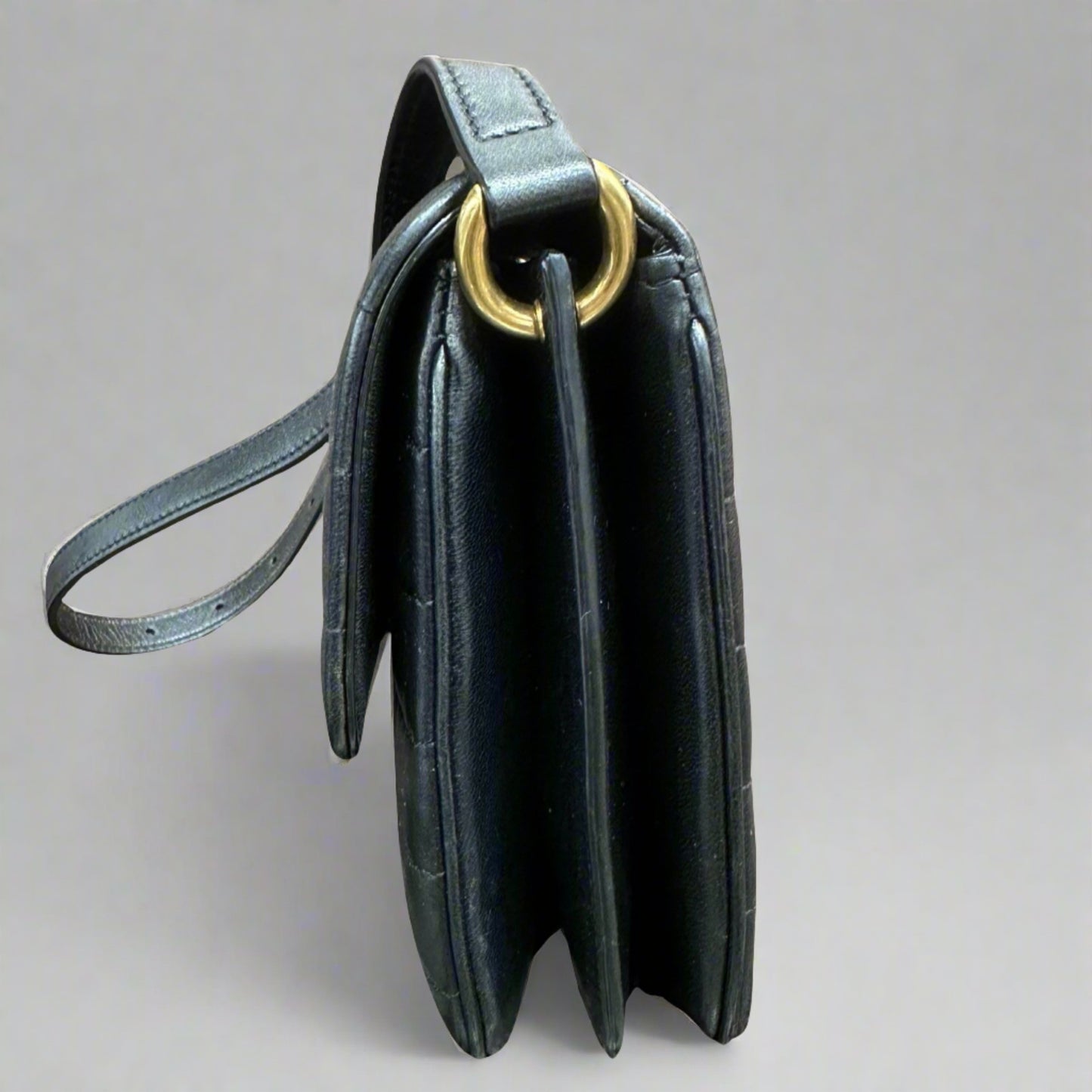 Side of black quilted bag