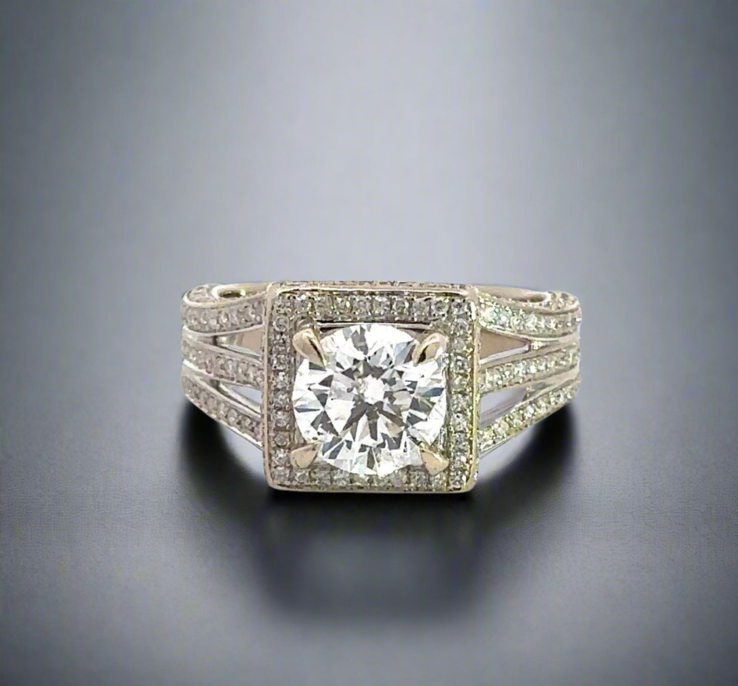top of 1.75 carat center-stone diamond ring with small round diamonds around center-stone and on band in 3 rows