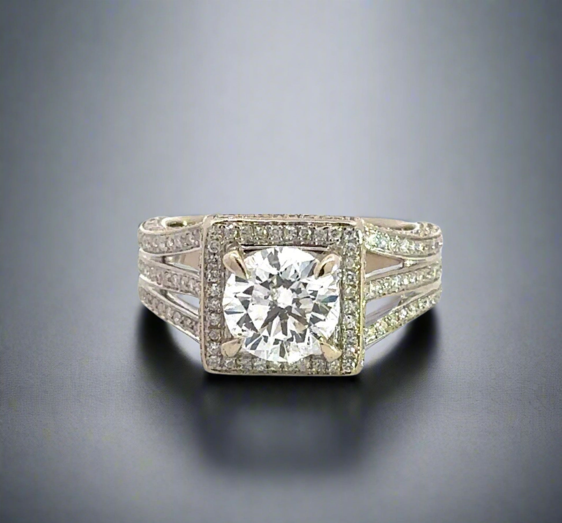 top of 1.75 carat center-stone diamond ring with small round diamonds around center-stone and on band in 3 rows