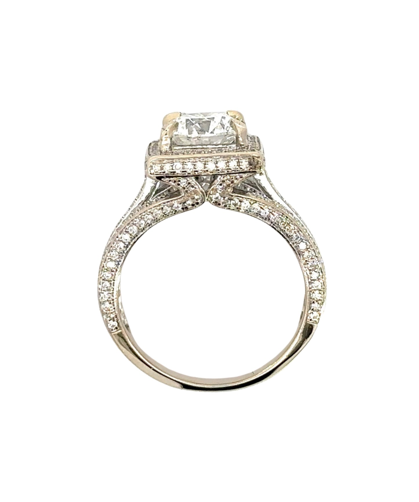 top of the side of the ring showing diamonds on the prongs, on side of band, and around center stone