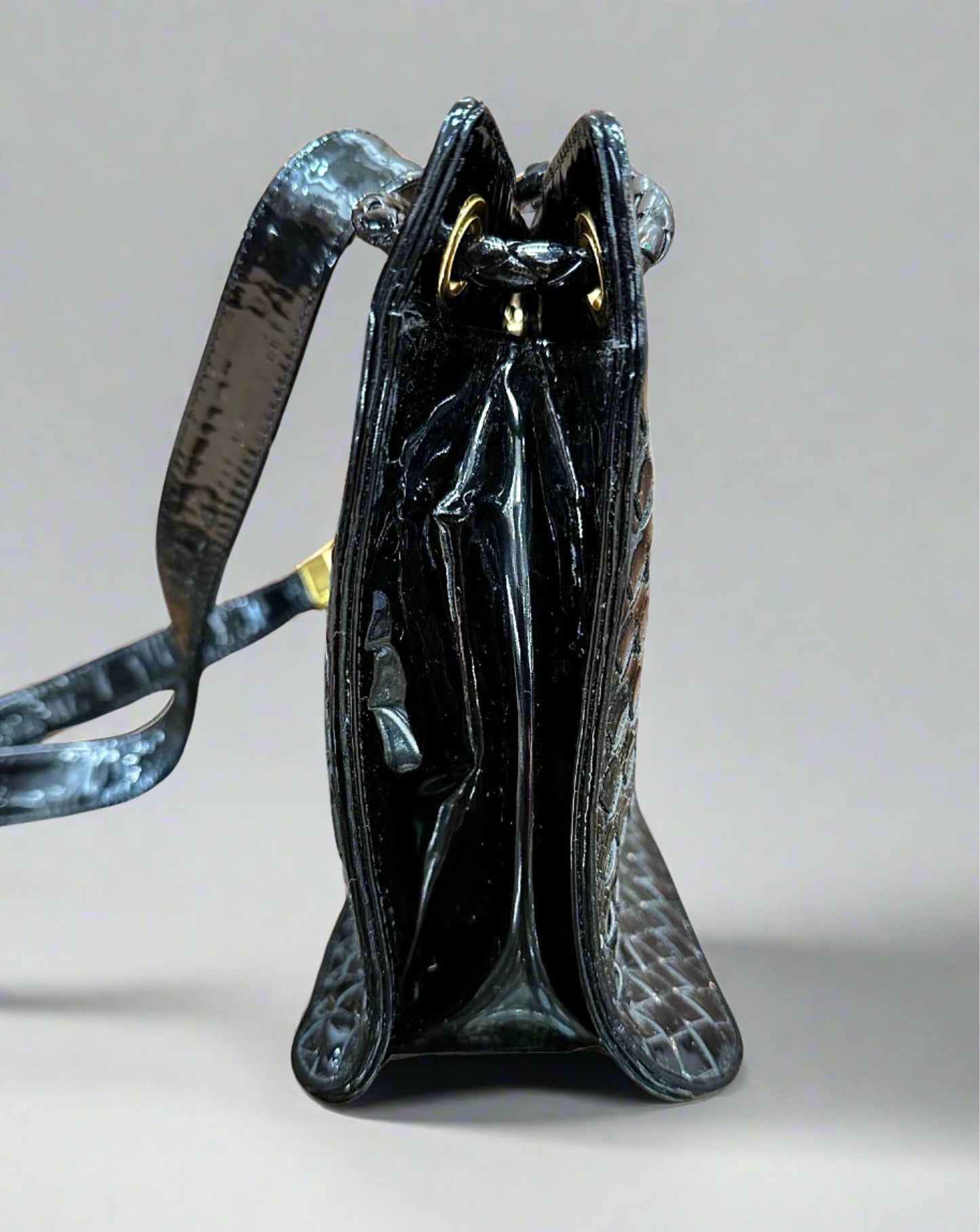 Side of black patent leather bag