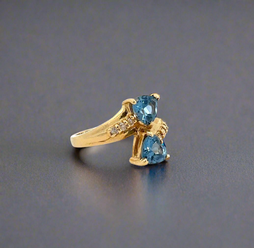 Diagonal view of blue gemstone and diamond ring