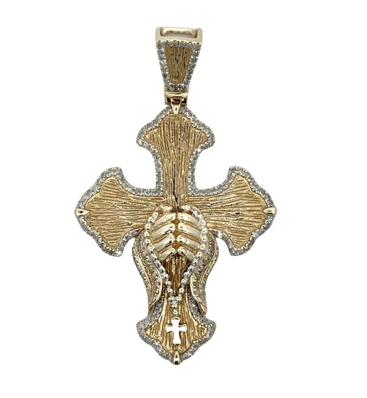 Textured yellow gold cross pendant with small round diamonds on the outline and praying hands holding a rosary necklace in the center