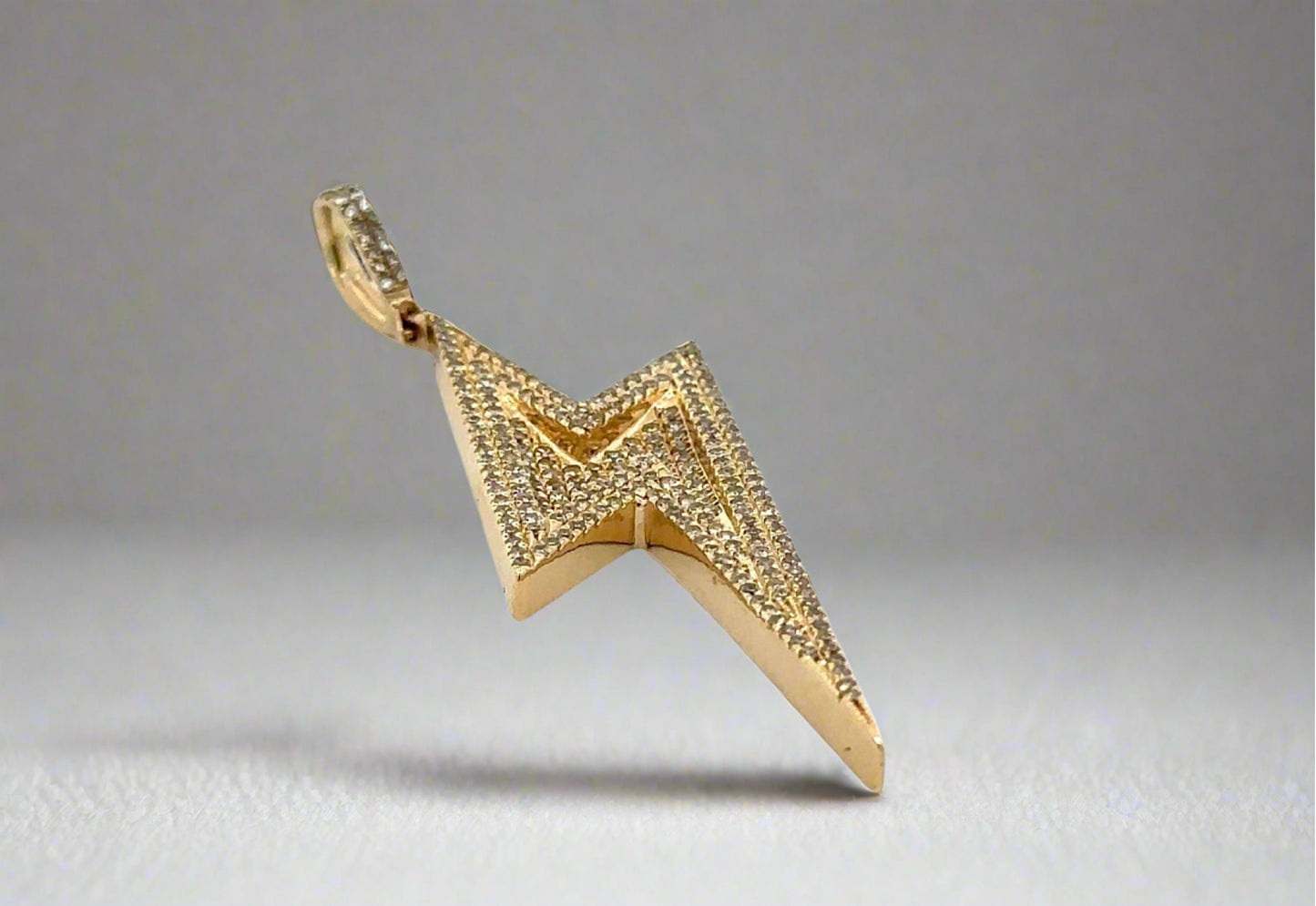 Bottom of yellow gold pendant with faint scratches on gold