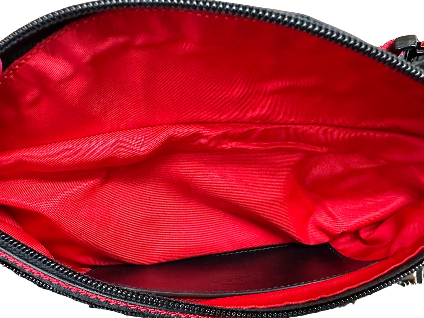 Big pocket of belt bag with red interior + black card slots