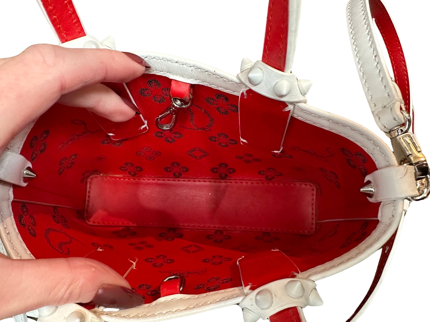 Interior of bag with red interior + black CL + Louboutin signature