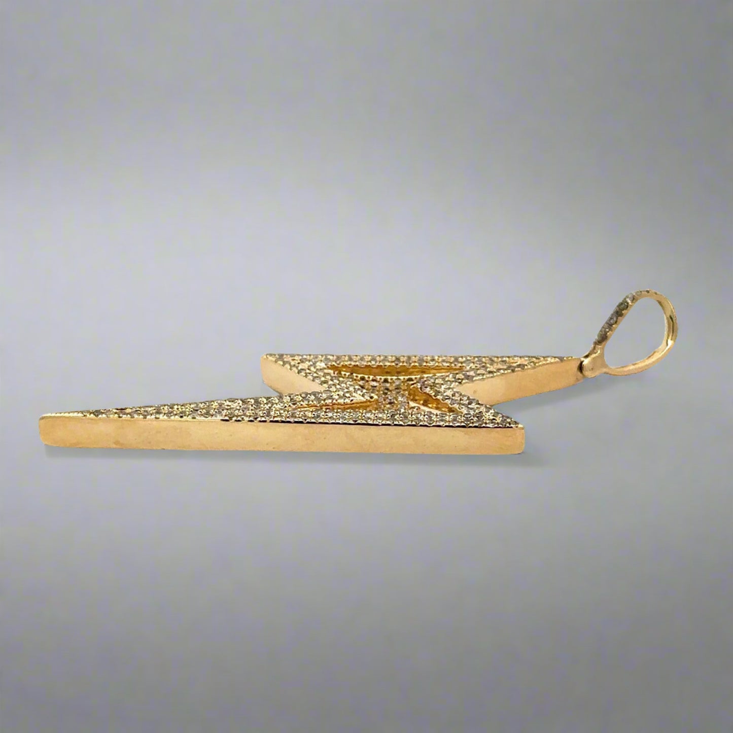 Side of yellow gold pendant with faint scratches on gold