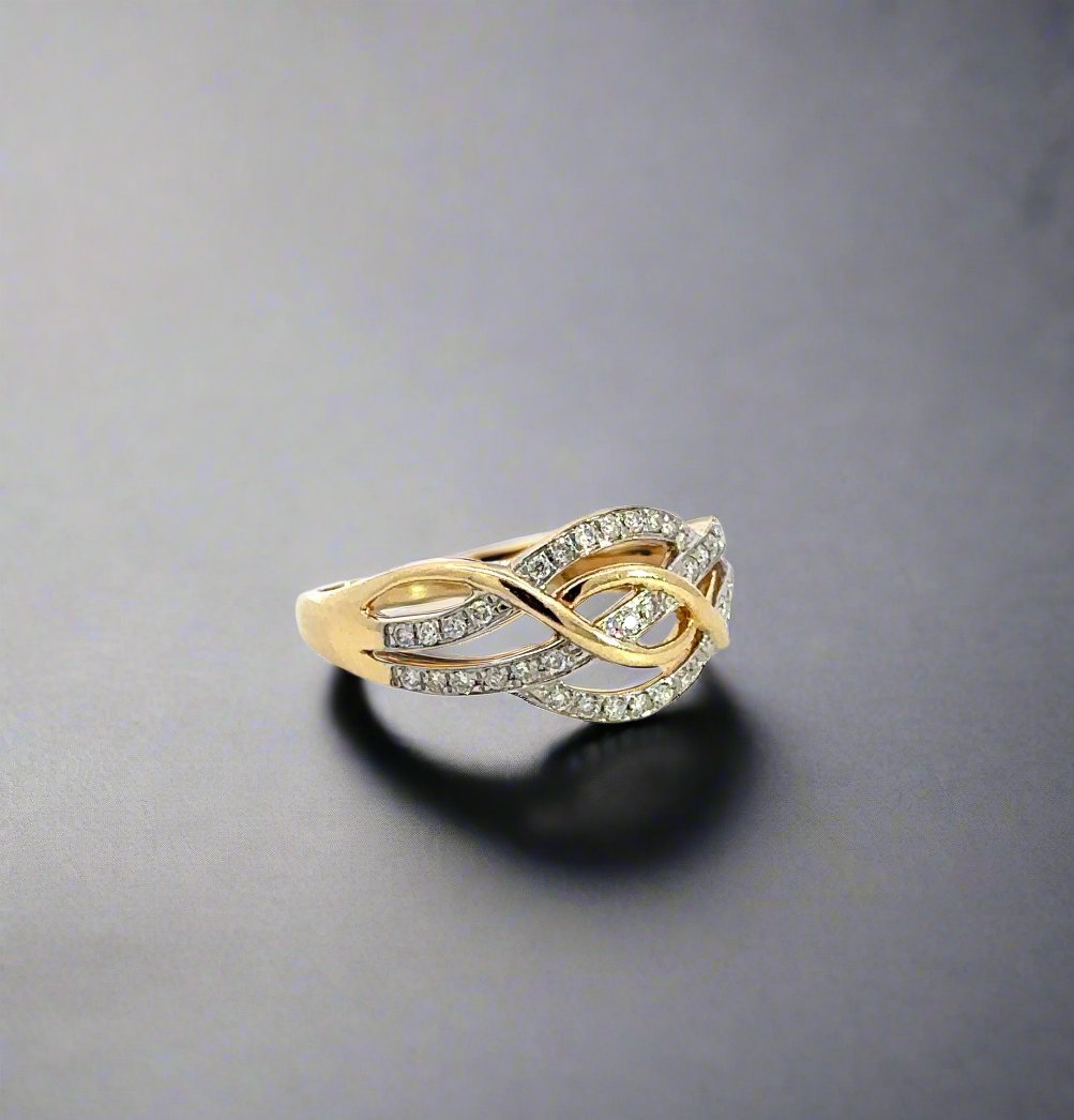 Diagonal view of yellow gold diamond crossover ring