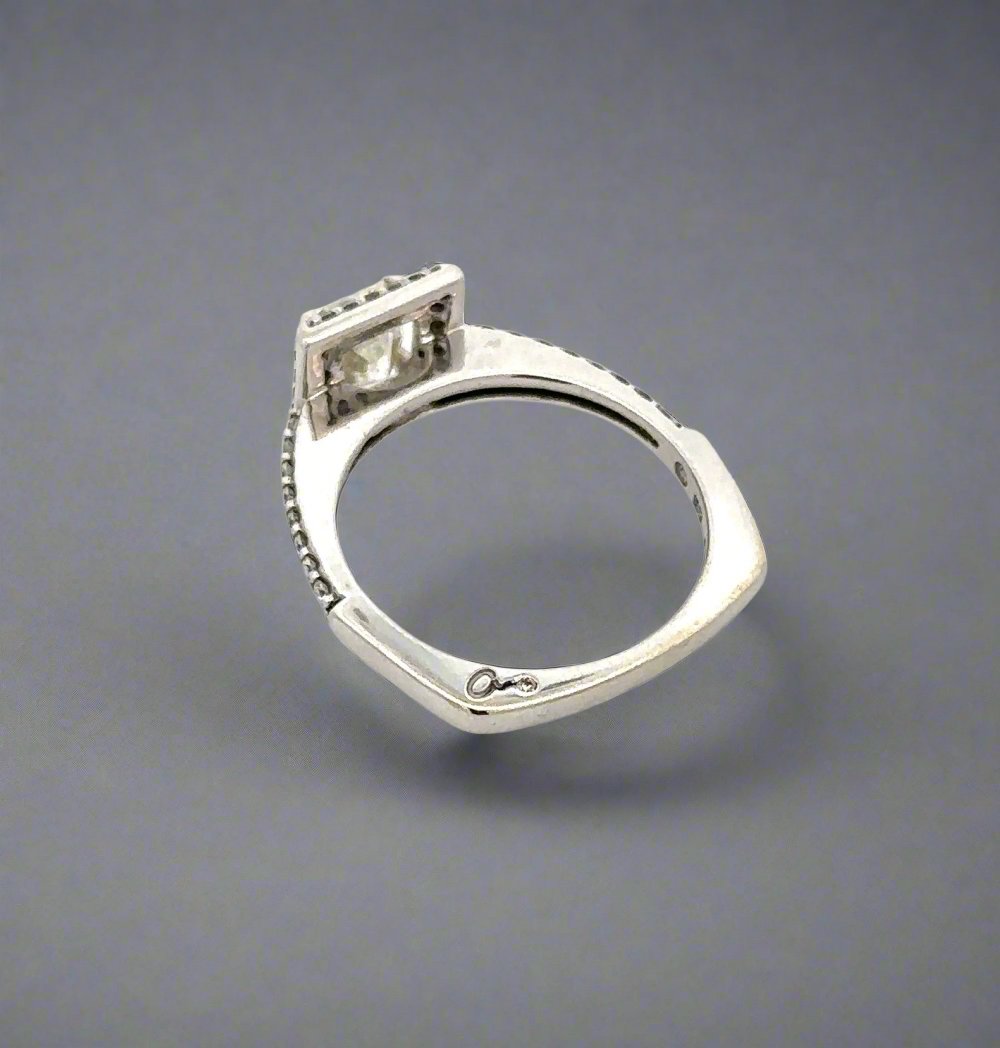 "a" signature with small round diamond on shank