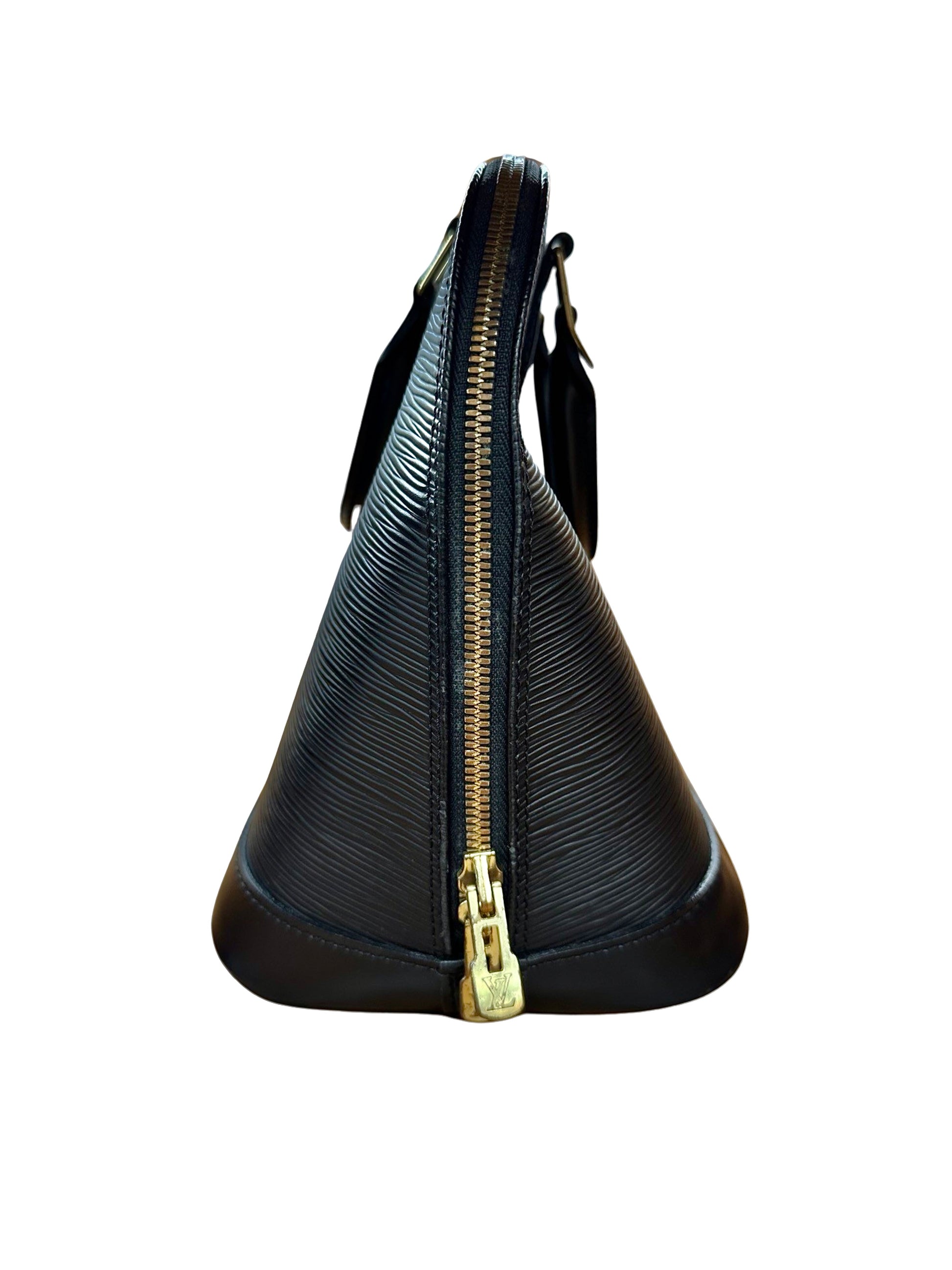 Side of black bag with gold zippers. The bag is out of shape on top