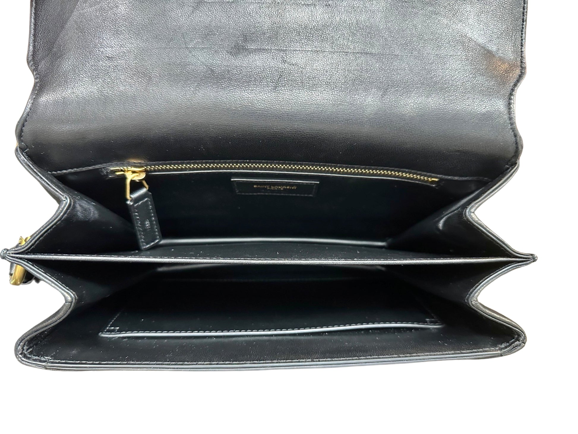 Top of bag with flap open showing interior. Scuff marks on the inside of the flap