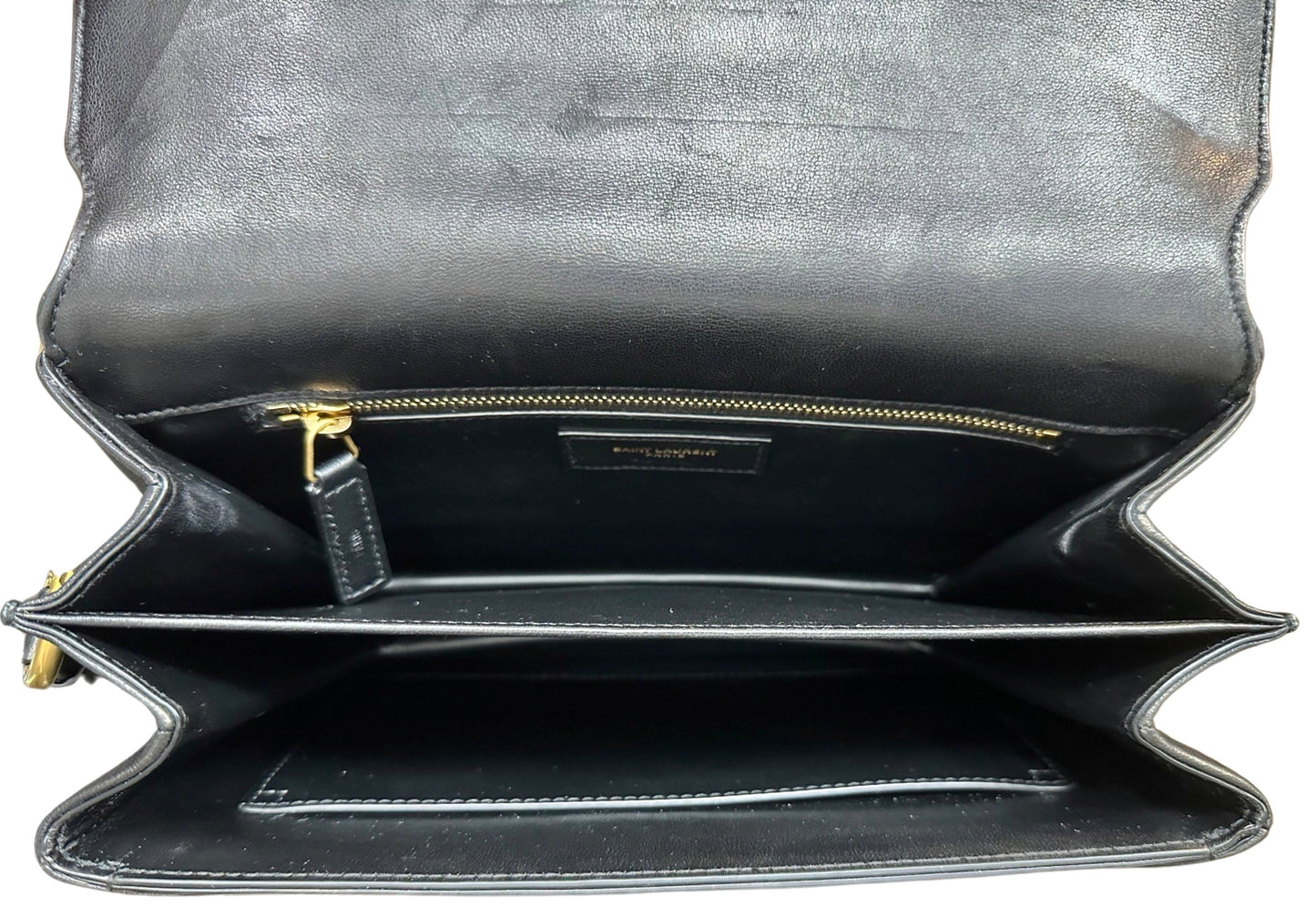 Top of bag with flap open showing interior. Scuff marks on the inside of the flap