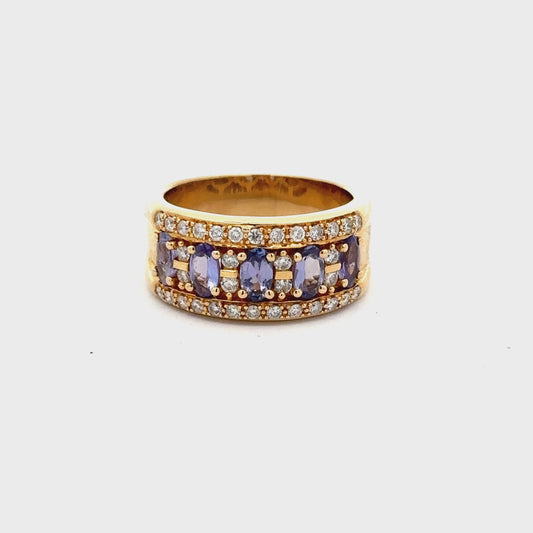 360 Video of yellow gold band ring with small round diamonds and 5 light blueish-purple oval colored gemstones and scratches on gold
