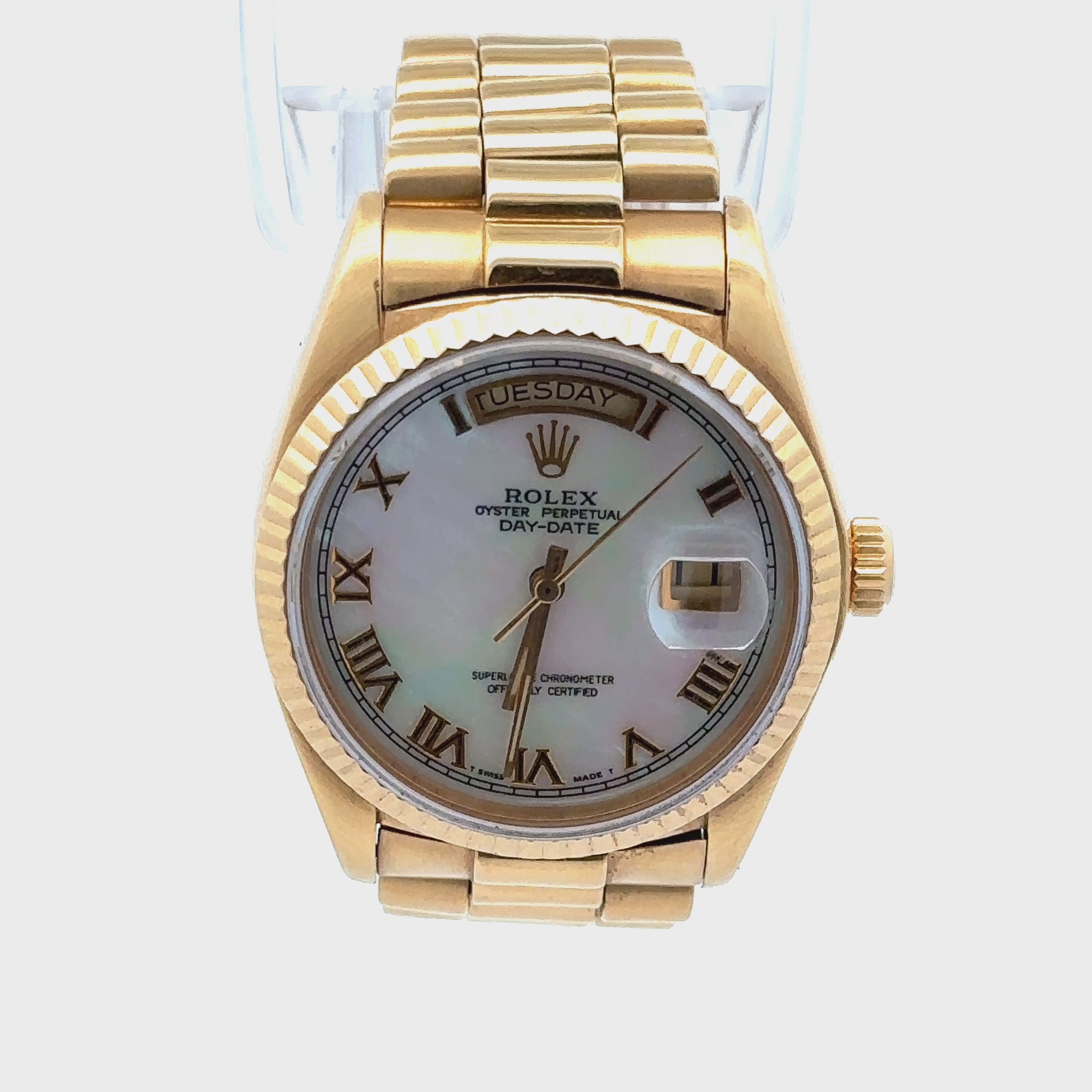 360 video of Rolex with white mother of pearl dial and 18K yellow gold case and band. The day of the week is on top of the dial by the 12 and the date is on the window on the side.