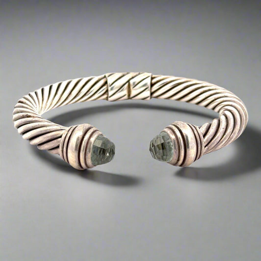 360 Video of silver bracelet with an open front. Scratches + dents on silver.