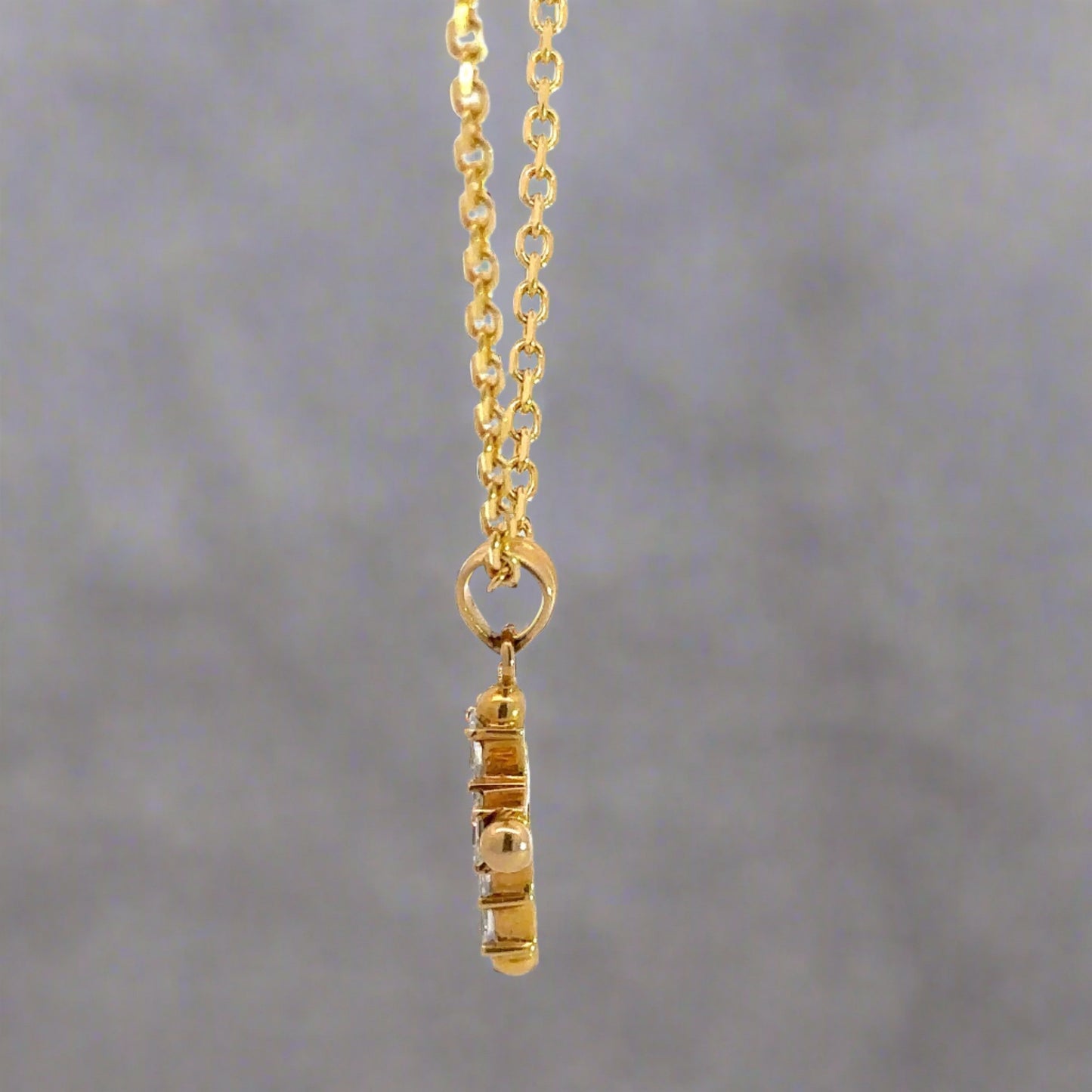 Side of cross pendant with round bail