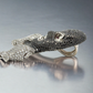 Ski mask face diamond pendant resembling a mask with gemstone details on a gray background