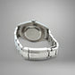 Silver watch case on a gray background