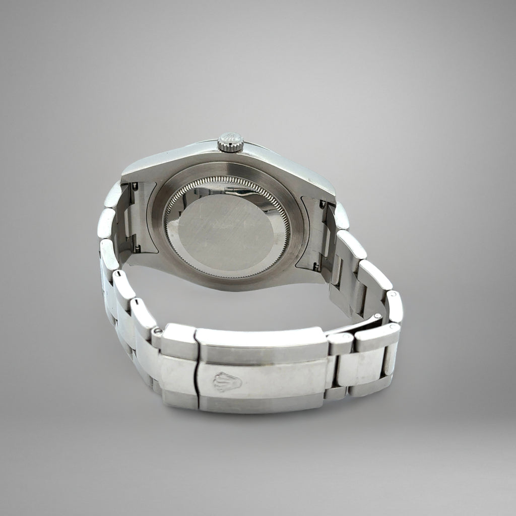 Silver watch case on a gray background