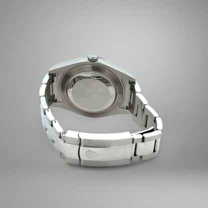 Silver watch case on a gray background