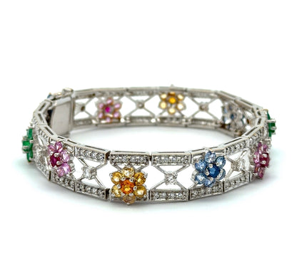 White gold bracelet with colorful gemstones and diamonds on a white background