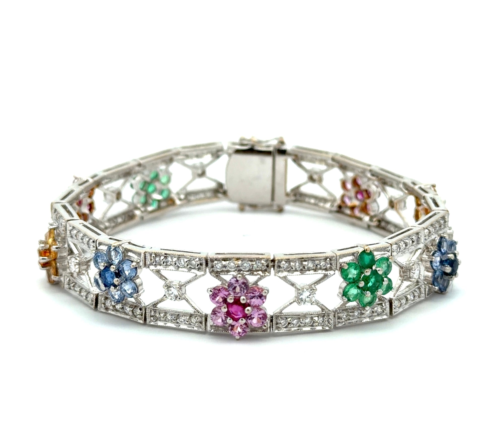 White gold bracelet with colorful gemstones and diamonds n a white background