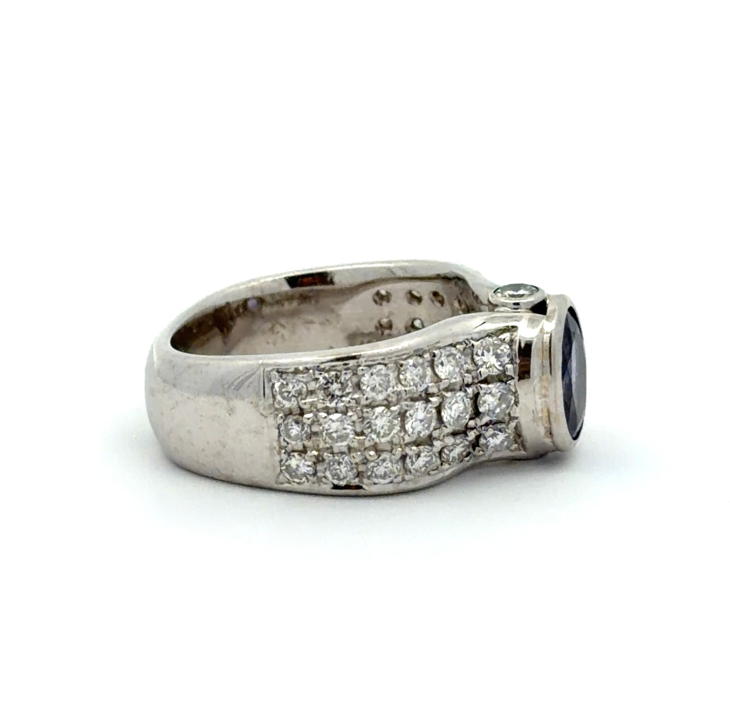 White gold ring with a Tanzanite oval gemstone and diamond accents on a white background