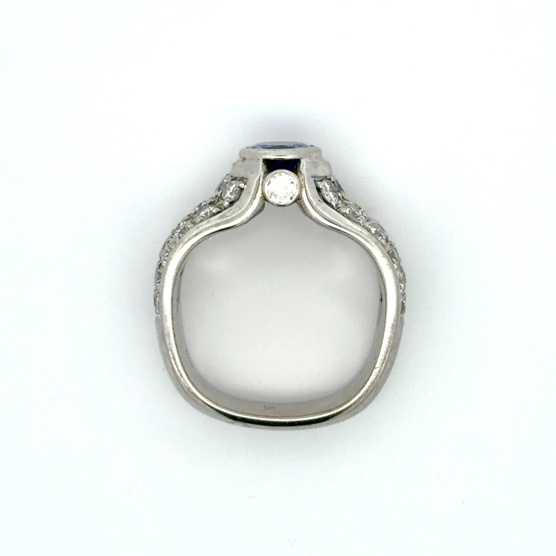 White gold ring with a Tanzanite oval gemstone and diamond accents on a white background