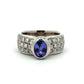 White gold ring with a Tanzanite oval gemstone and diamond accents on a white background