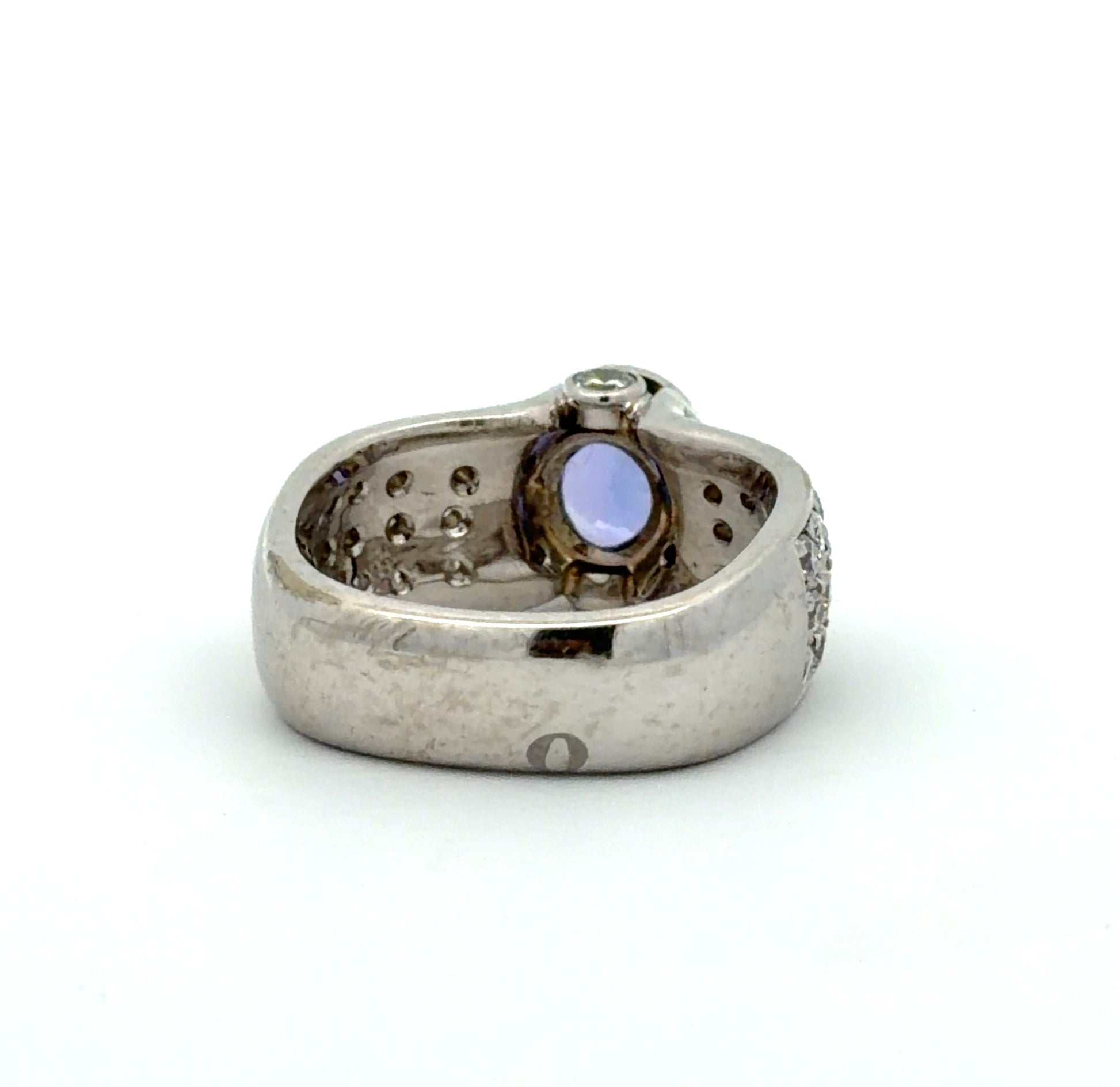 White gold ring with a Tanzanite oval gemstone and diamond accents on a white background