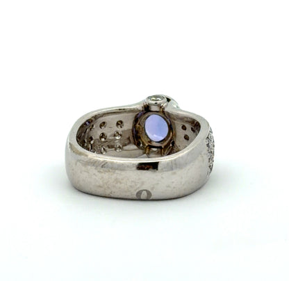 White gold ring with a Tanzanite oval gemstone and diamond accents on a white background