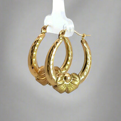 Diagonal view of yellow gold bow hooops