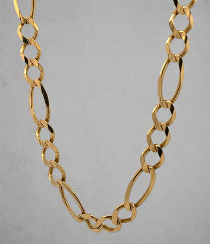 hanging yellow gold figaro link chain