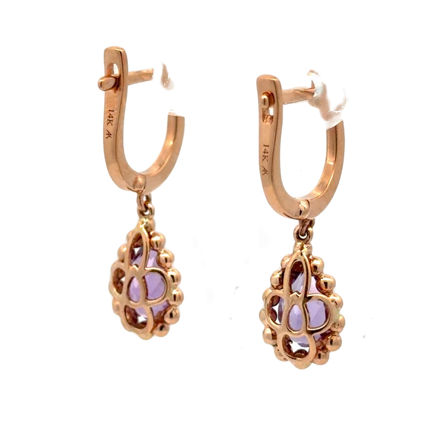 A pair of rose gold huggie hoop earrings with dangling filigree teardrop charms set with light purple amethyst crystals, shown on a plain white background.