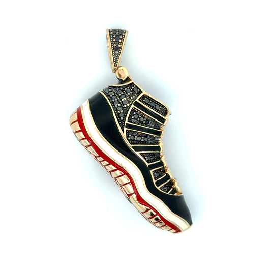 Shoe-shaped pendant with black and red design on a white background
